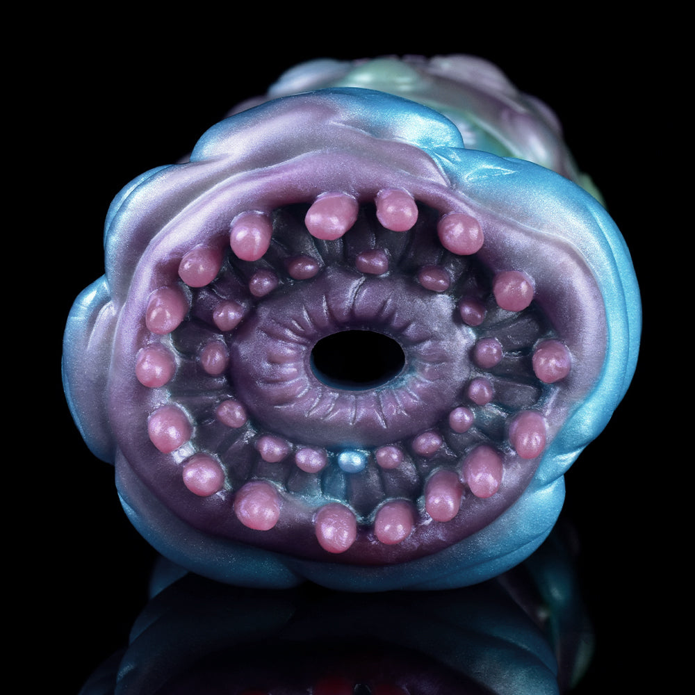 Close-up of the inner opening with small pink nodules inside a blue alien sleeve