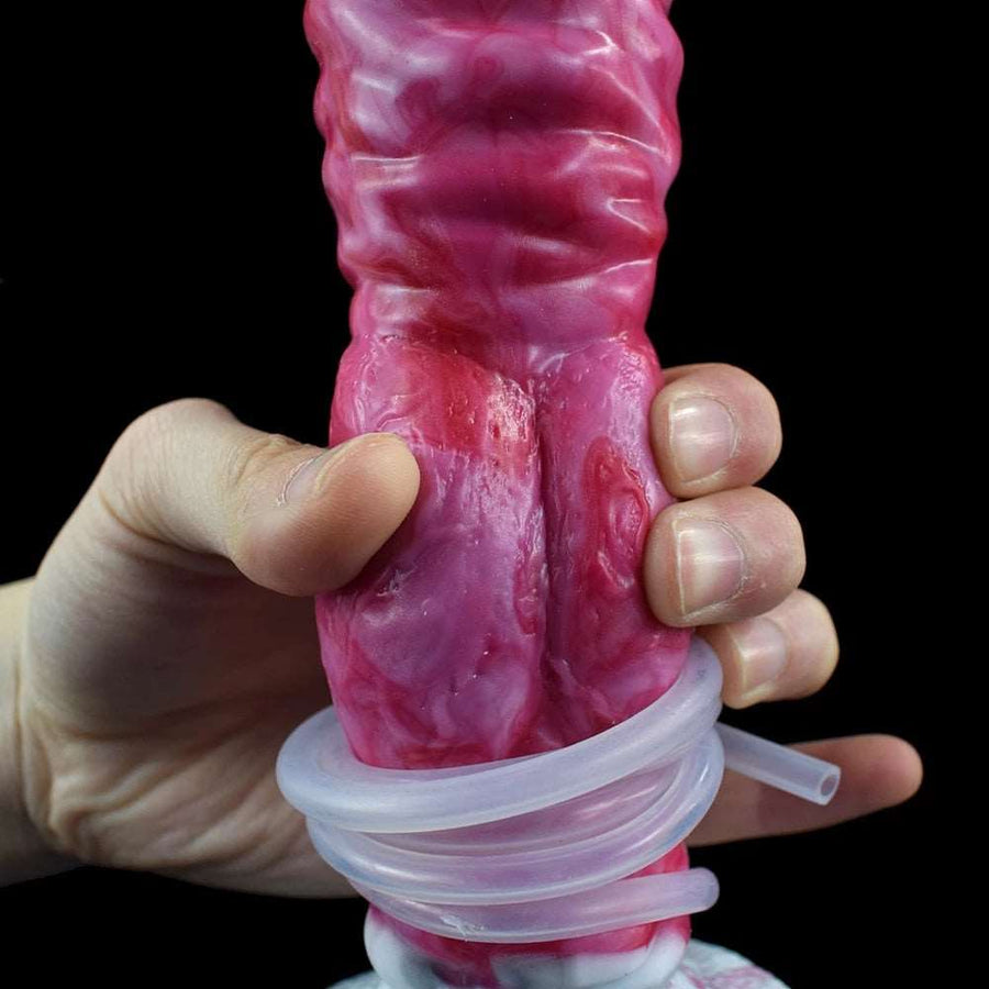 Close-up of pink realistic dog-knot style sex toy with clear ring and grip.