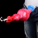 Inflatable horse-shaped dildo with red/pink body and blue base near jeans