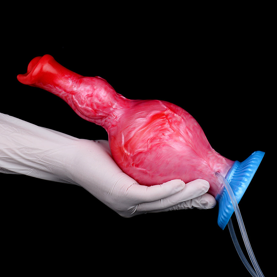 Inflatable red/pink sex toy with blue base and clear tube beside gloved hand