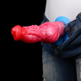 Inflatable knot dildo in blue airbag, red-pink textured shaft near denim pants