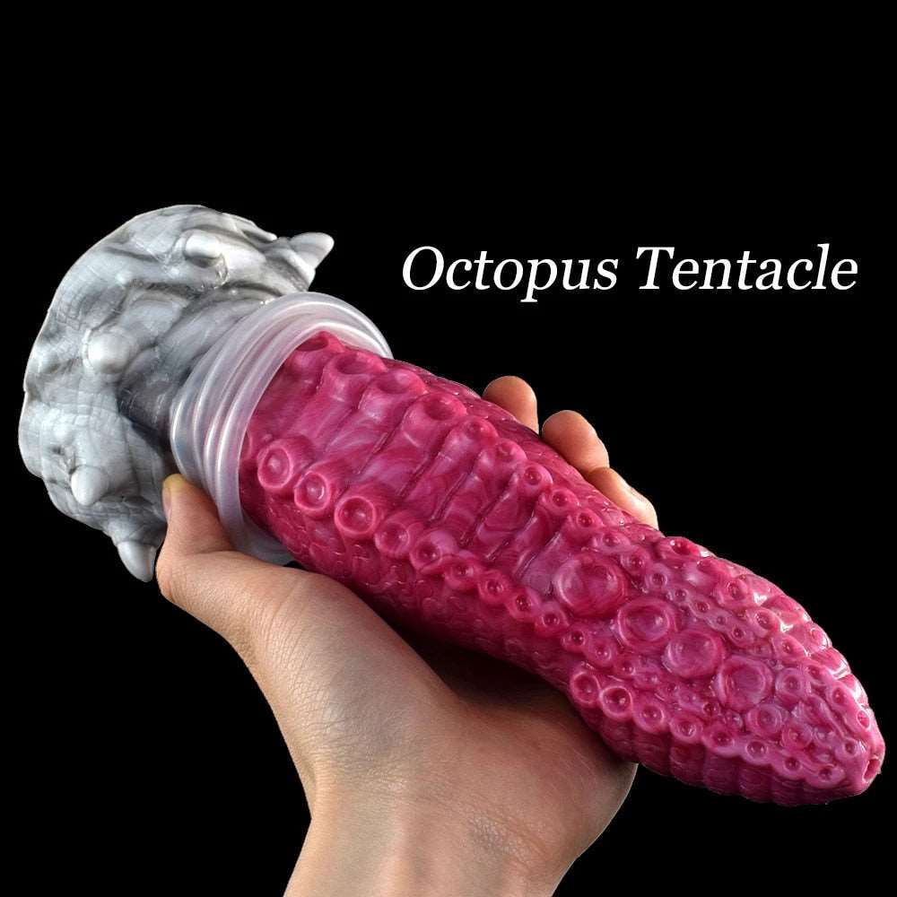 Octopus tentacle dildo in hand, fuchsia/pink textured tentacle with white suction base (Gory)