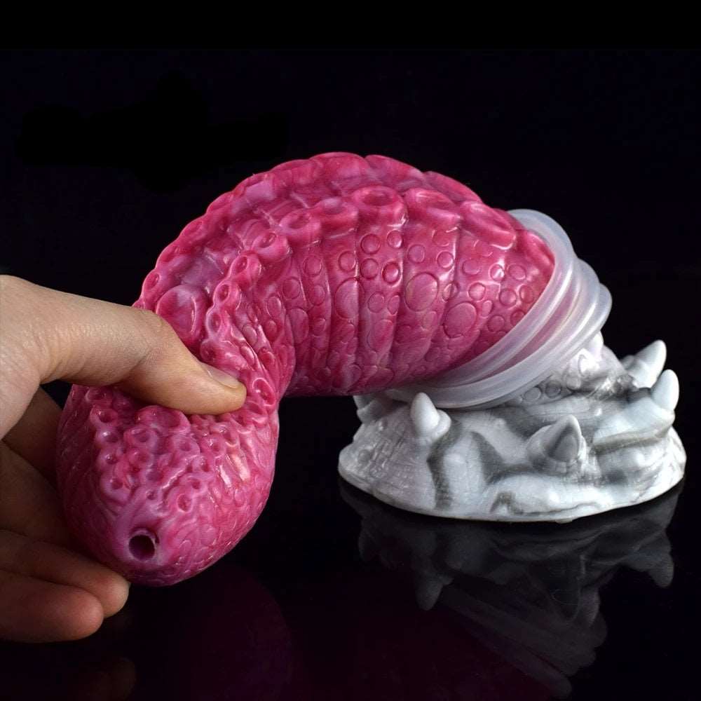 Octopus tentacle dildo, pink textured body with white base and visible nozzle/tube (Gory)