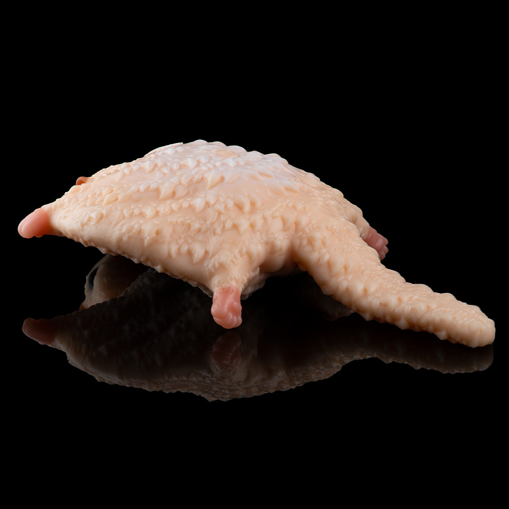 Peach plush cat figure lying on side with textured fur
