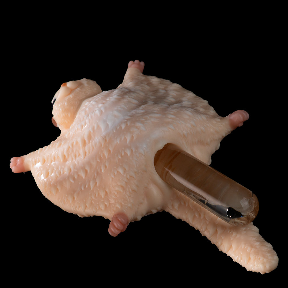 Peach plush cat with clear tube inserted in opening, lying curled