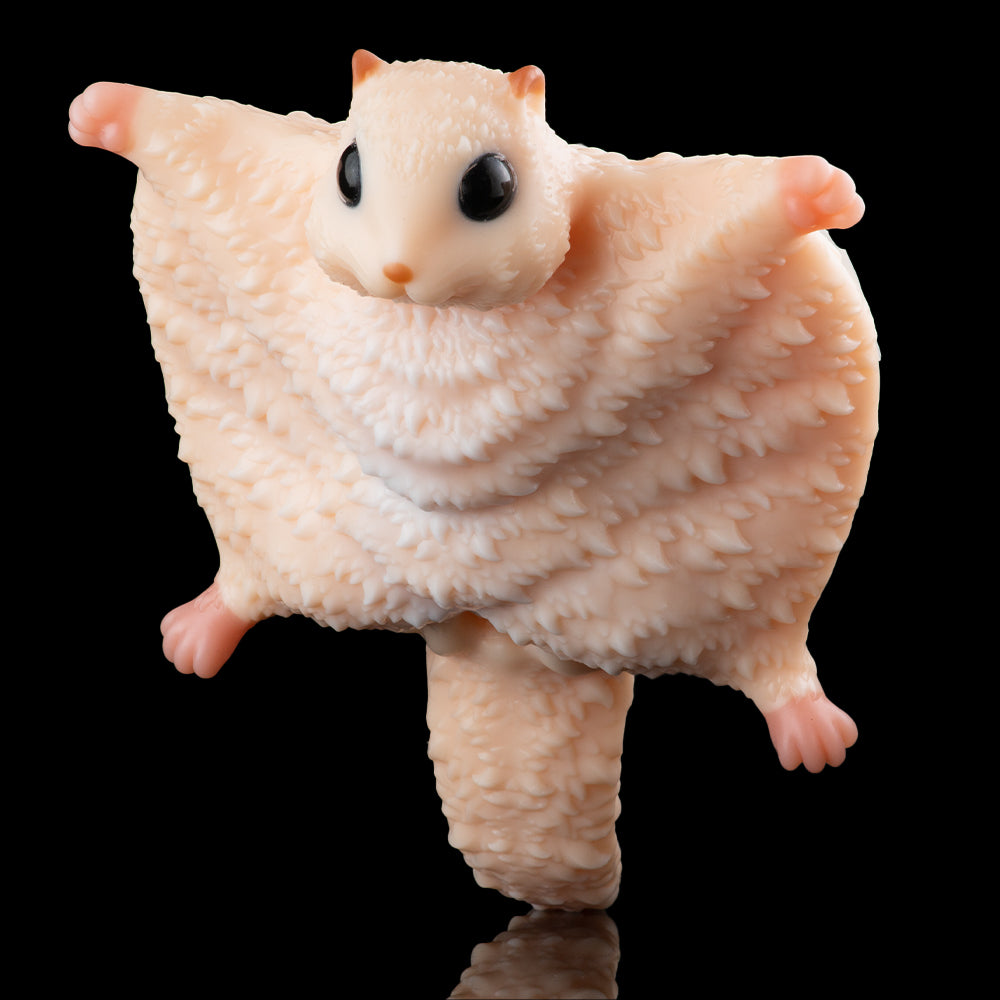 Beige plush animal toy with big ears, black eyes, and spread wings