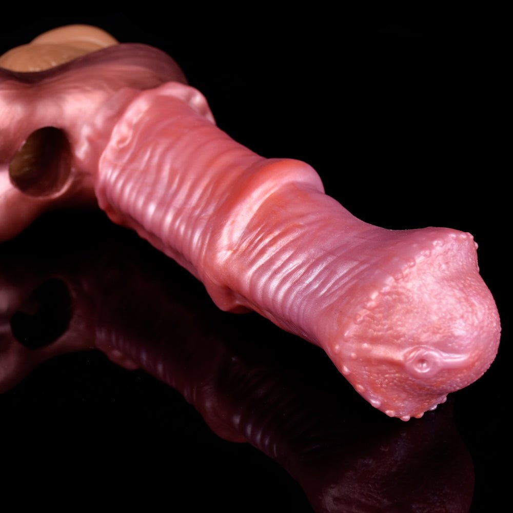 Close-up of shiny pink cock sleeve tip, with small circular detail and textured ribs