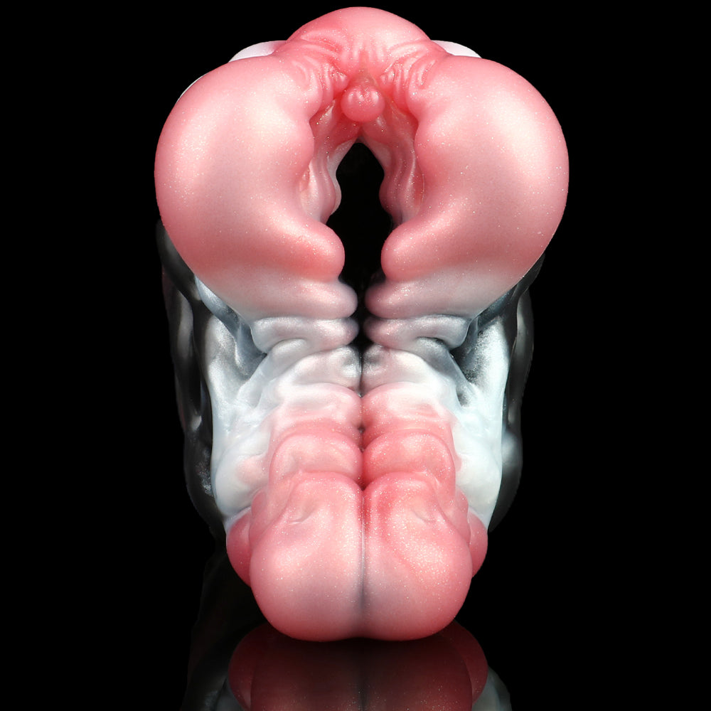 Front view of pink and dark molded sex toy with central ridge and open cavity