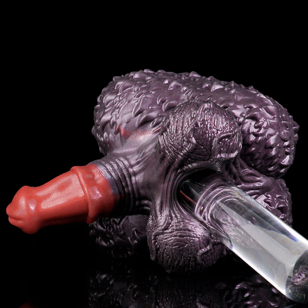 Purple textured creature toy with red forefinger and clear blade-like piece.