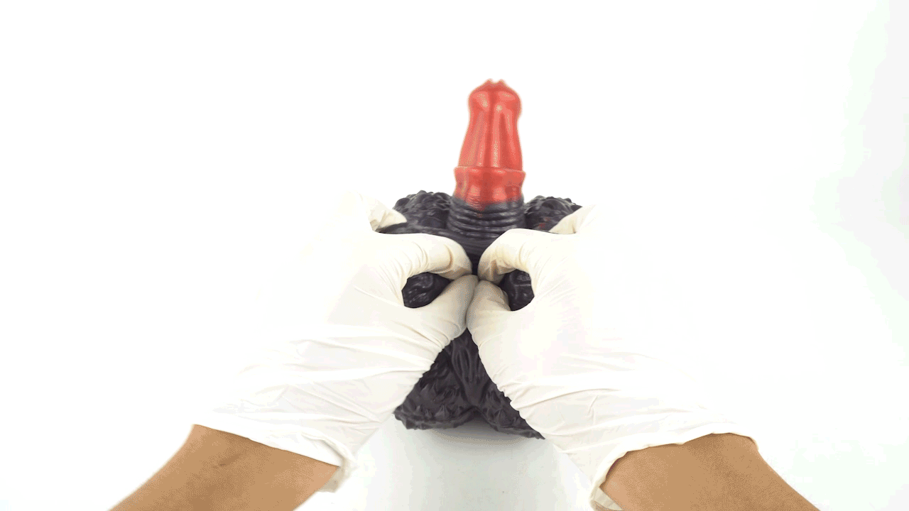 Dark textured sex toy with red inner tip