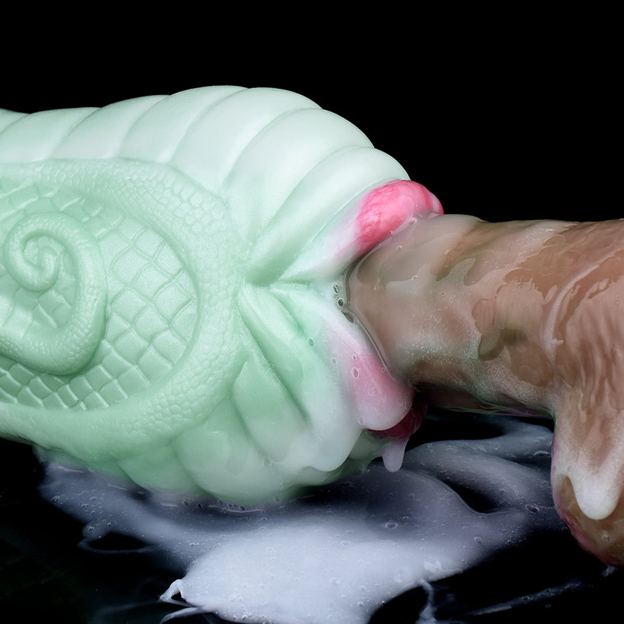 Detail view of light green snake pleasure toy opening with pink insert