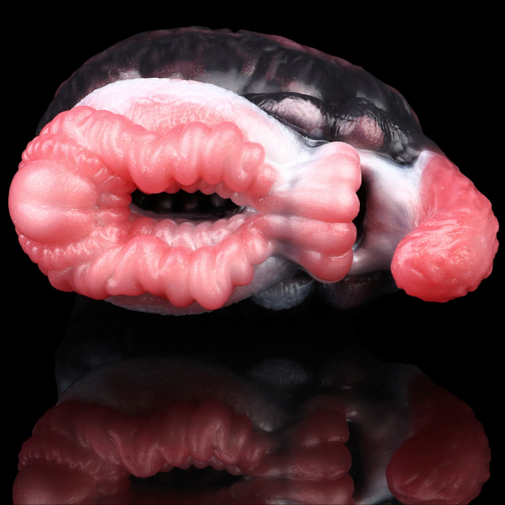 Dual-hole creature toy showing two pink ribbed inserts and black-and-white fur detail