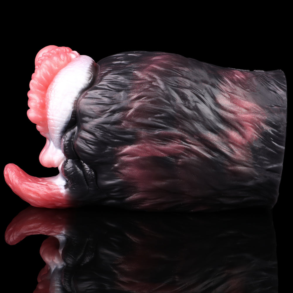 Side angle view of dual-hole creature toy with pink interior ridges and black fur