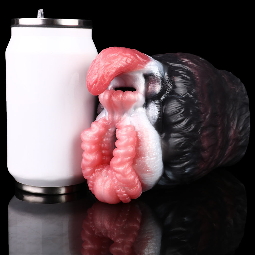 Dual-hole creature toy with pink ribbed openings beside white accessory