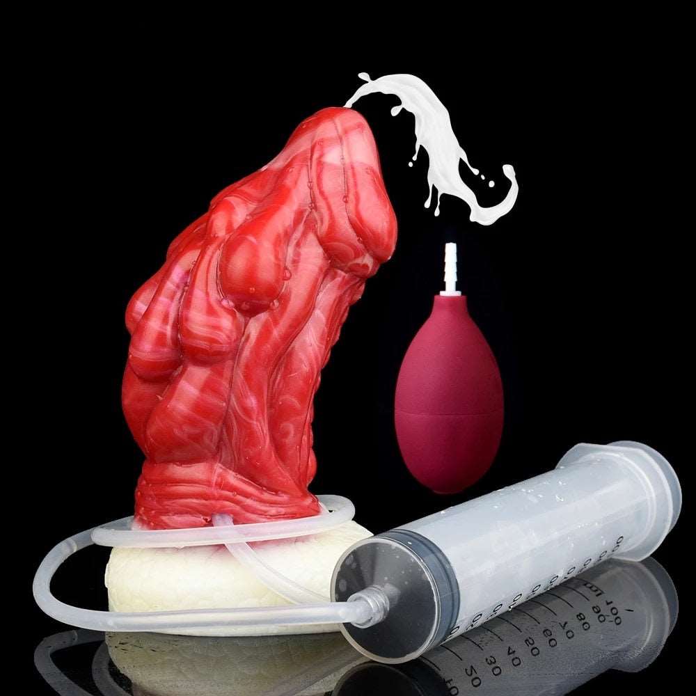 Red dragon butt plug with white base and clear pump tube, with maroon squeeze bottle.