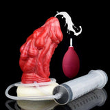 Red dragon butt plug with white base and clear pump tube, with maroon squeeze bottle.