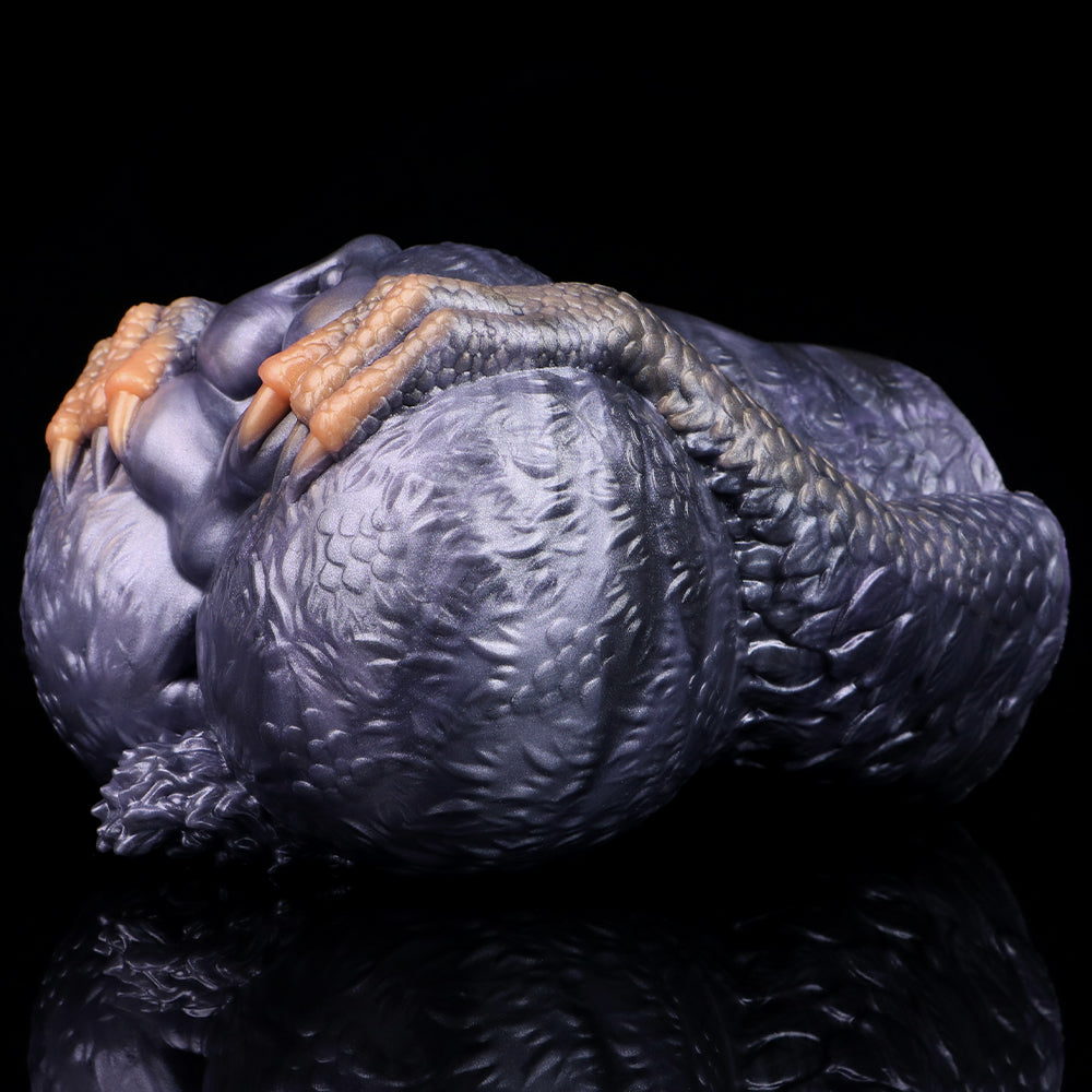 Dual-hole animal fleshlight, angled view showing orange grip ridges over the openings