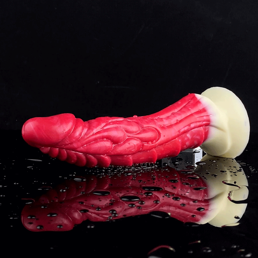 Red curved dragon vibrator with cream tip and base, glossy rippled texture.