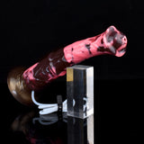 Horse-shaped dildo with attached hose and pink nozzle, beside measuring block