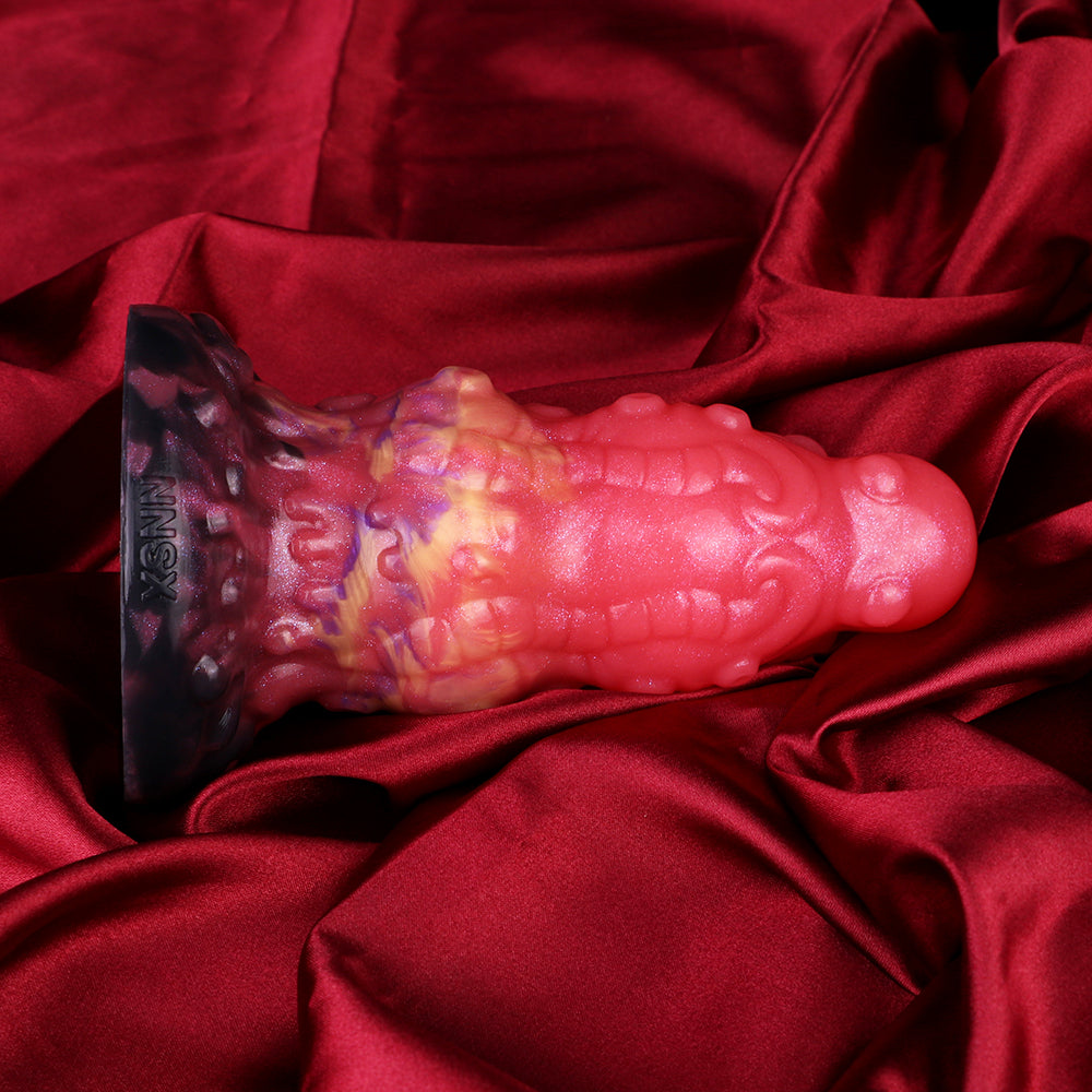 Alien butt plug with ribbed texture, dark purple tip and glossy pink body