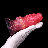 Alien butt plug in glove, ribbed pink body with dark purple rear rim
