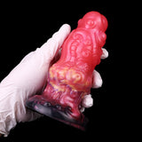 Ribbed alien butt plug close-up, pink body with purple speckled base