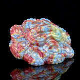Iridescent octopus grinder sex toy, side view with textured tentacle bumps