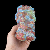 Back view of octopus grinder sex toy, iridescent blue-pink swirl texture