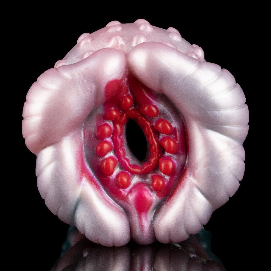 Alien-themed fleshlight-style stroker with pink outer ring and red inner cavity texture