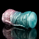 Teal end of the alien Fleshlight with glossy ridges and small raised bumps for grip.