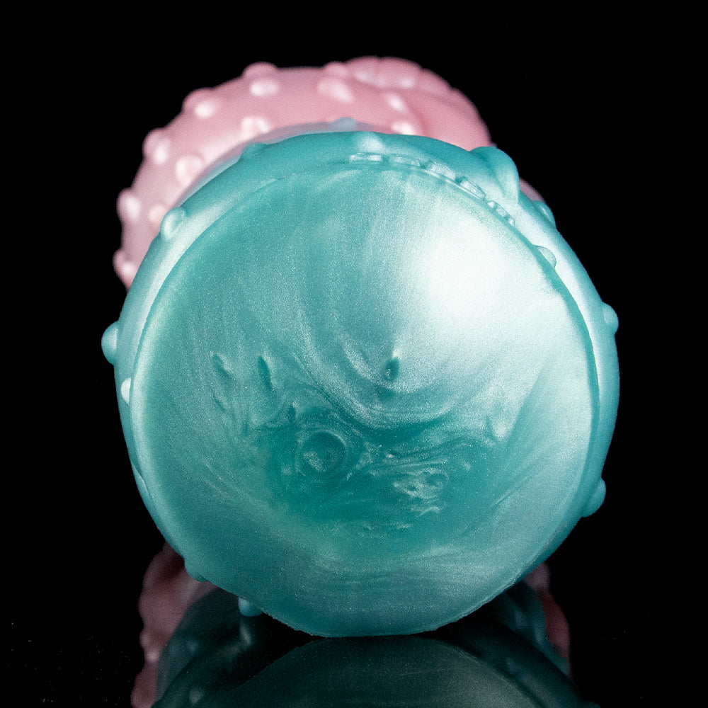 Round teal Fleshlight end cap with fine molded texture and tiny raised studs.