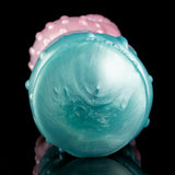 Round teal Fleshlight end cap with fine molded texture and tiny raised studs.