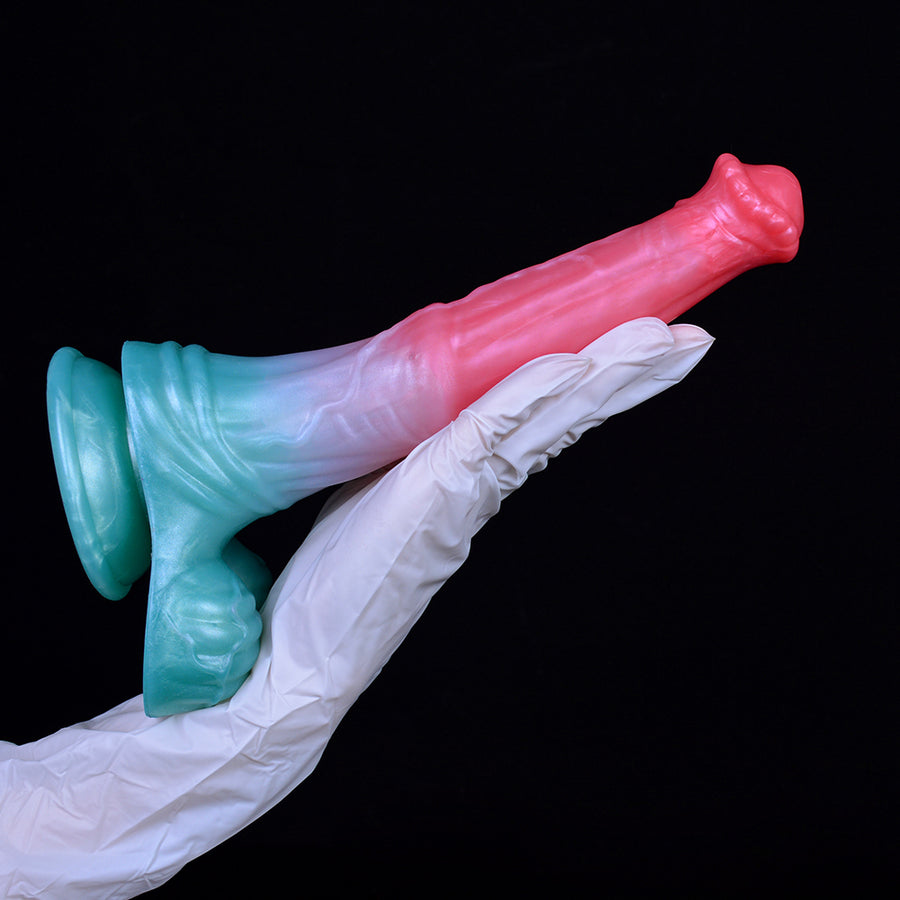 Pegasus-themed dildo held with gloves: pink shaft fading to light blue at base.