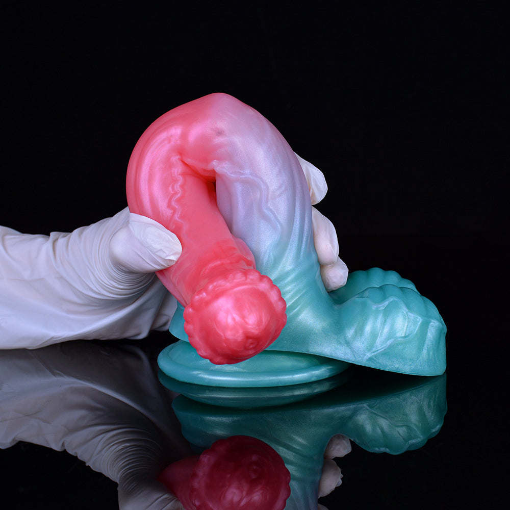 Close-up of horse dildo at blue base, pink head and white glove visible