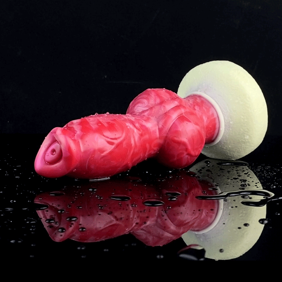 Wet red silicone dog-knot butt plug with flared cream base, side view