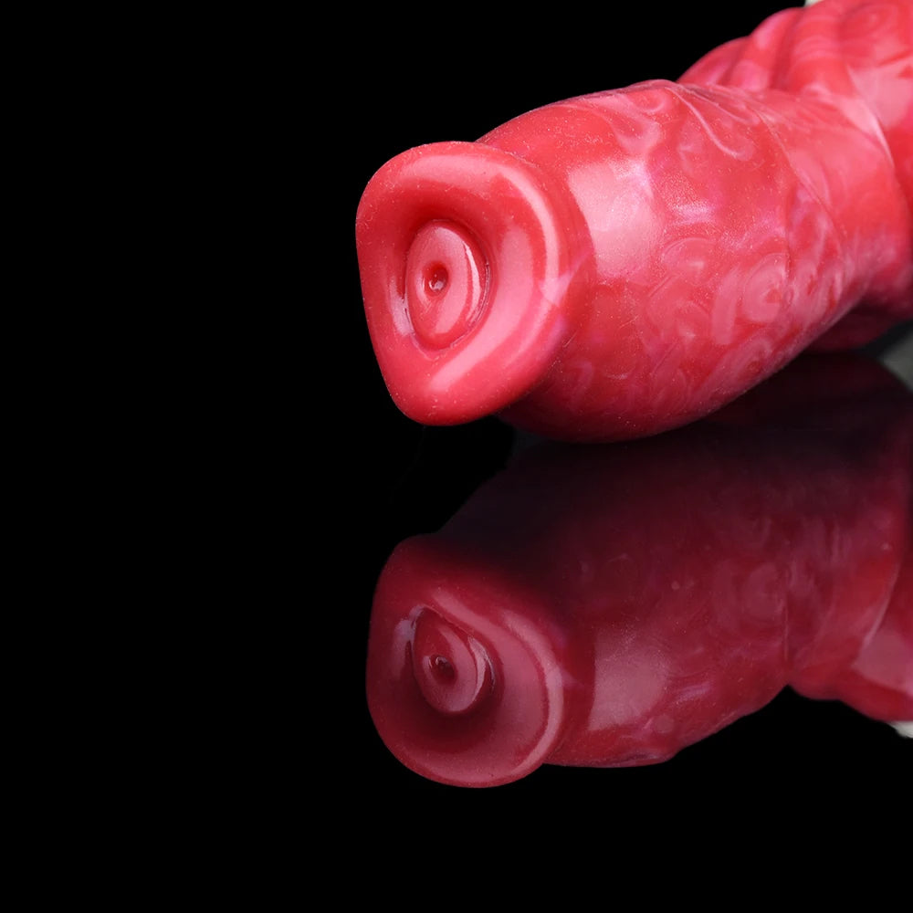 Close-up of red silicone dog-knot butt plug tip with round opening