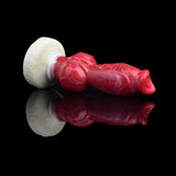 Side view of red silicone dog-knot butt plug with flared cream base