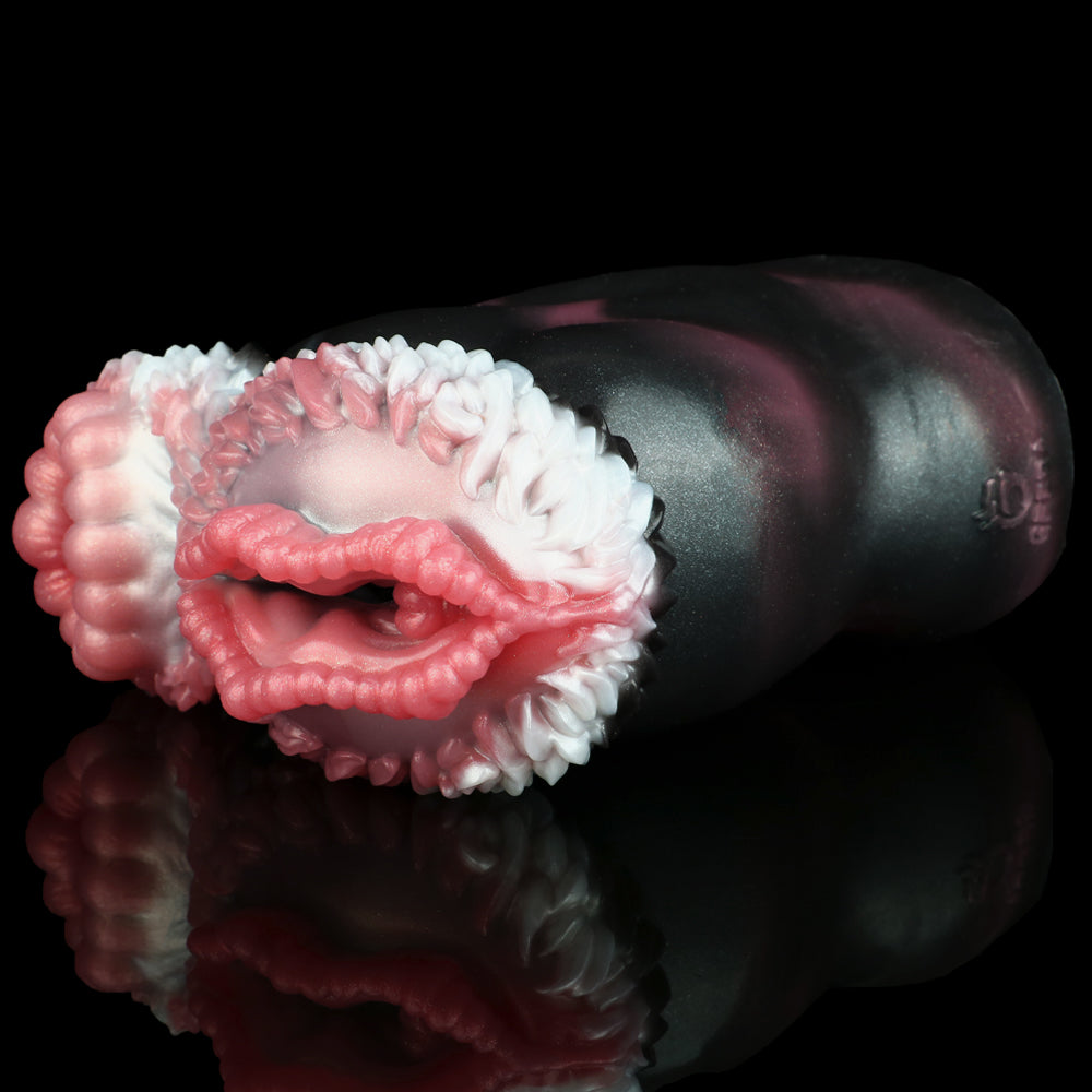 Curled dual-hole pocket masturbator with ribbed pink/white opening textures on dark body