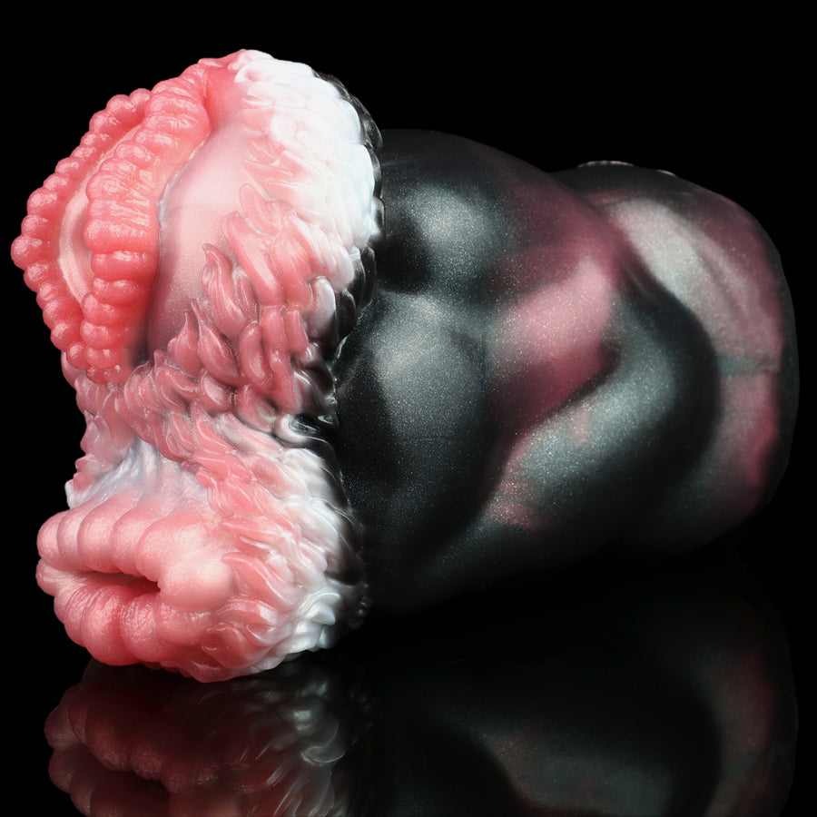 Dual-hole pocket masturbator close-up with pink/white textured openings on black body