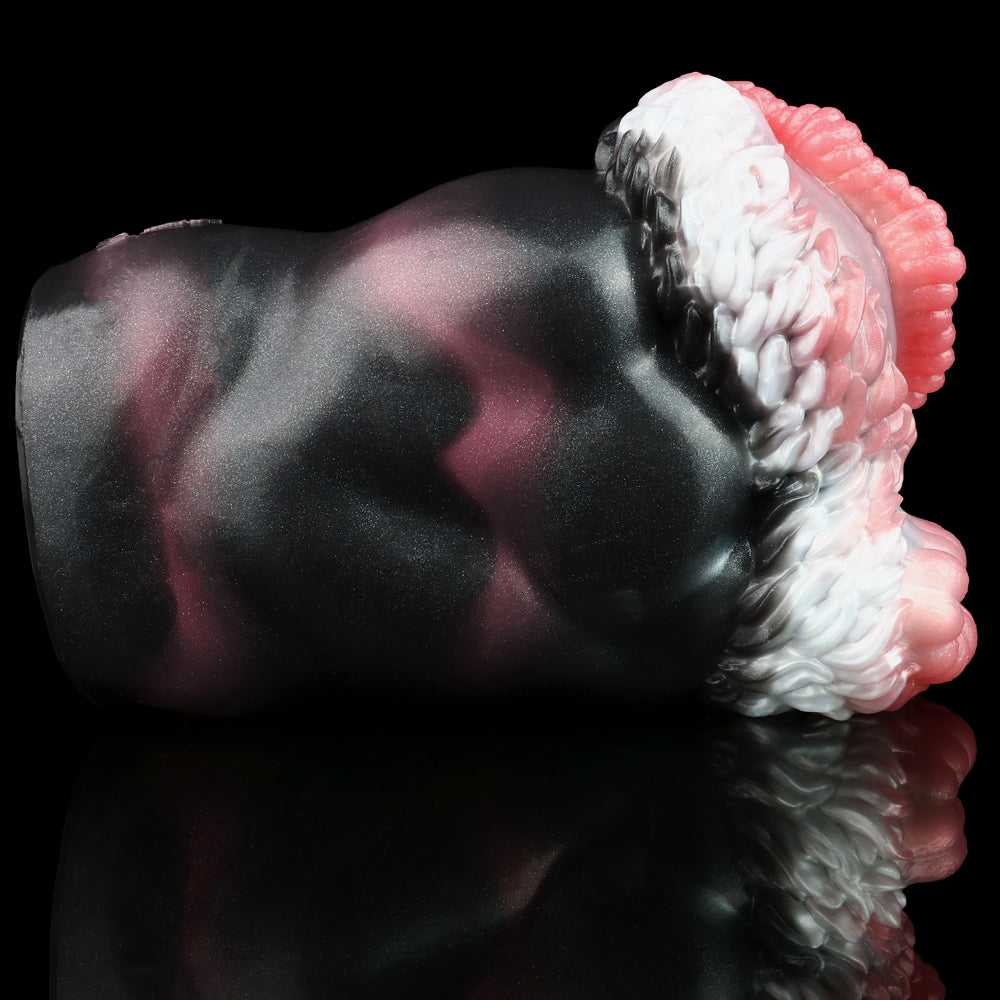 Close-up of dark textured body with ribbed pink-and-white rim near dual openings