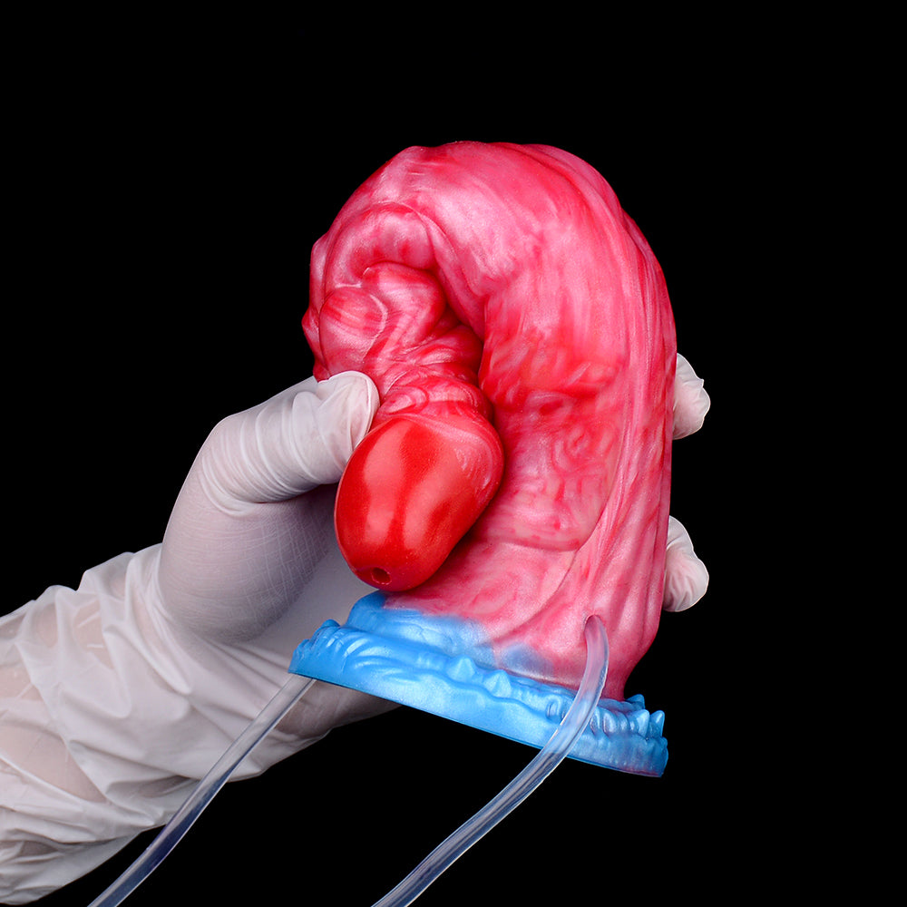 Roter Drachen-Dildo mit blauem Sockel am Schlauch; in Hand vorgezeigt