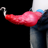 Roter Drachen-Dildo mit blauem Sockel; Schlauch und Ventil sichtbar