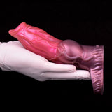 Pink dog sheath sleeve over white glove, molded texture on side