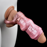 Pink cock sleeve worn over a realistic molded base, curved shape