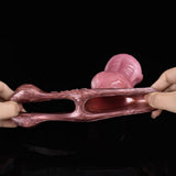 Pink extender sleeve held open, showing interior and long curved shaft