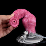 Hand holding pink textured dog dildo showing circular tip opening