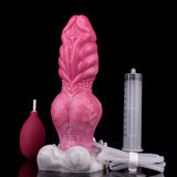 Rosafarbener Fantasy-Dildo mit Schlauch, heller Basis, daneben Behälter und Messrohr