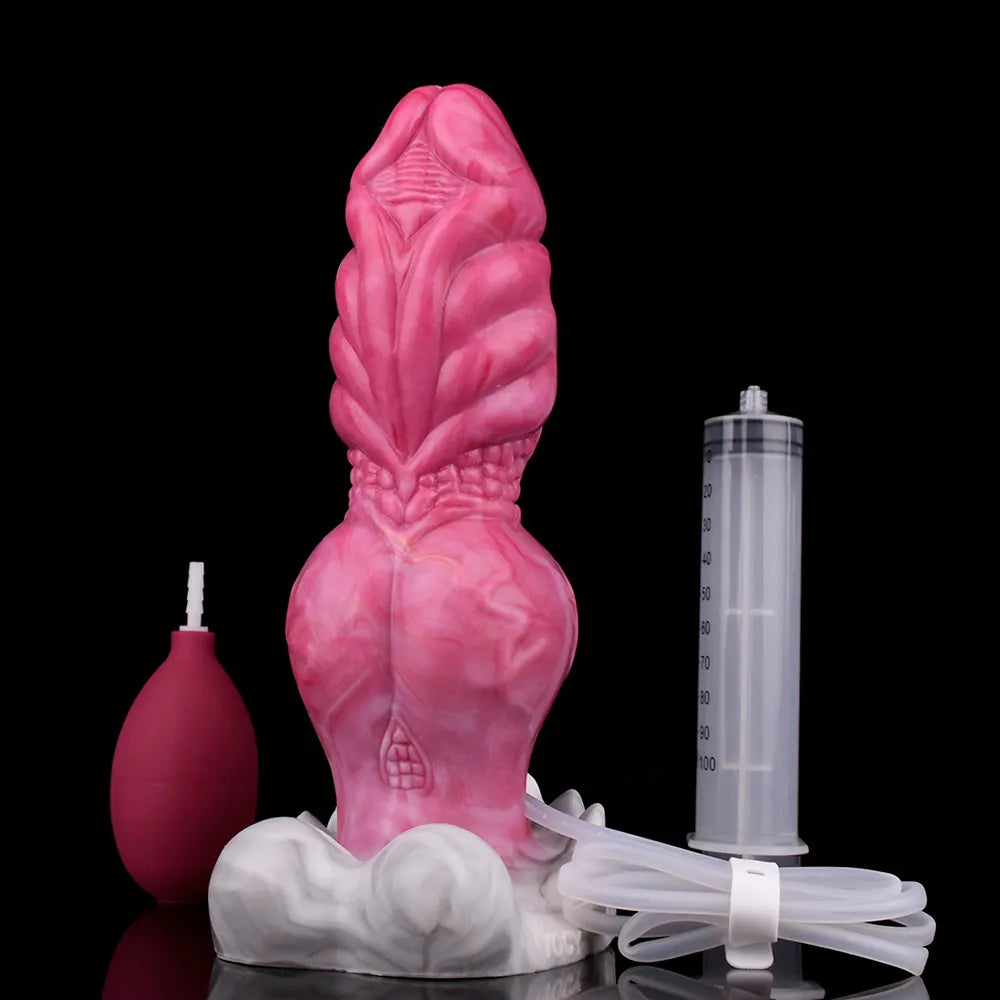 Knotted pink dildo with ribbed hood detail and base, plus syringe and tubing