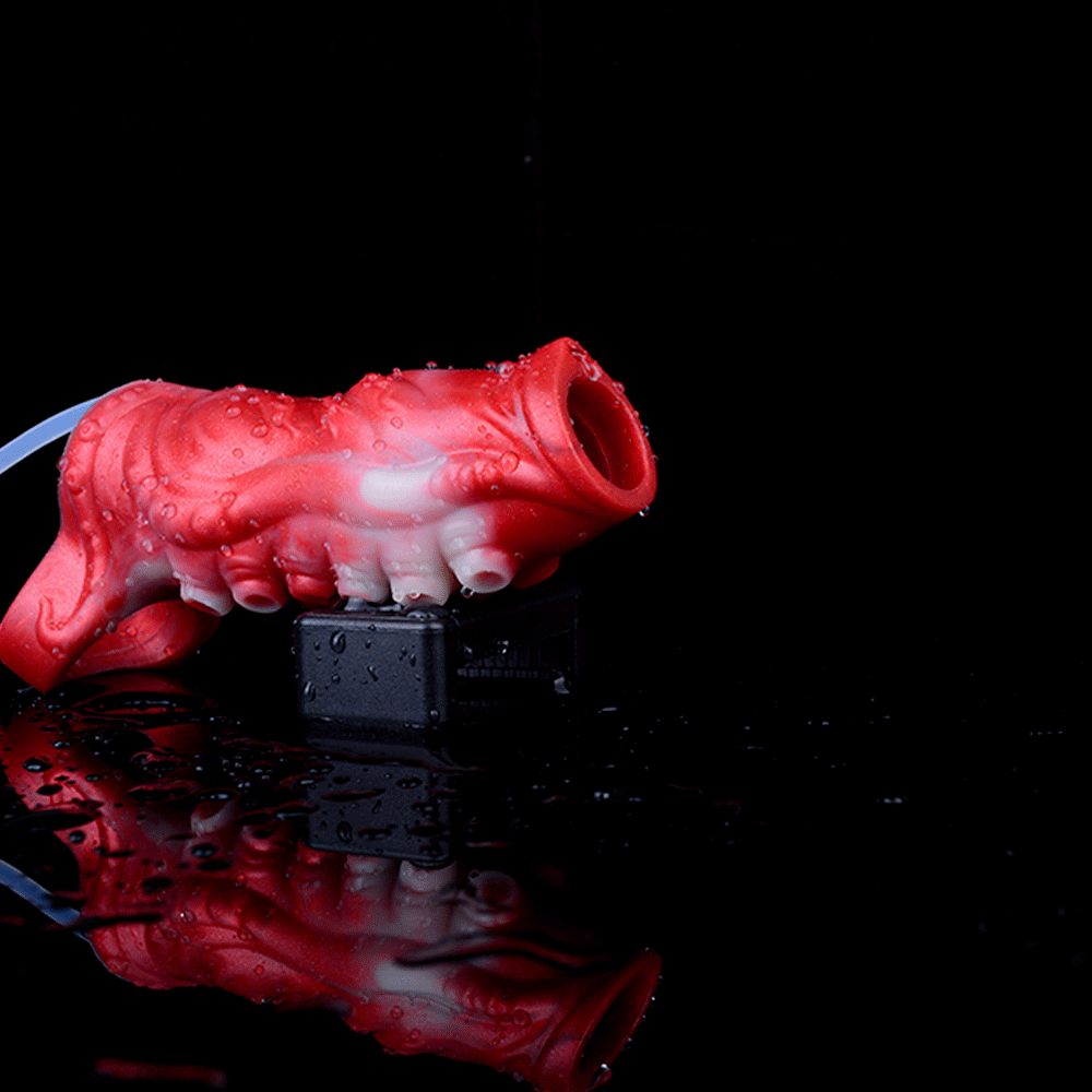 Red and translucent tentacle-sleeve design with open tip; squirting stream nozzle shown