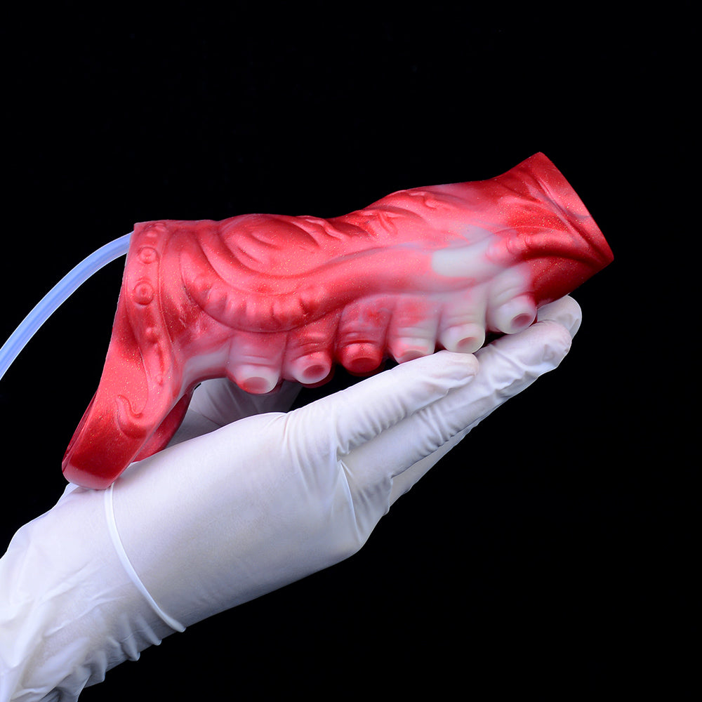 Red kraken tentacle penis sleeve with suction-like tips, held in white glove